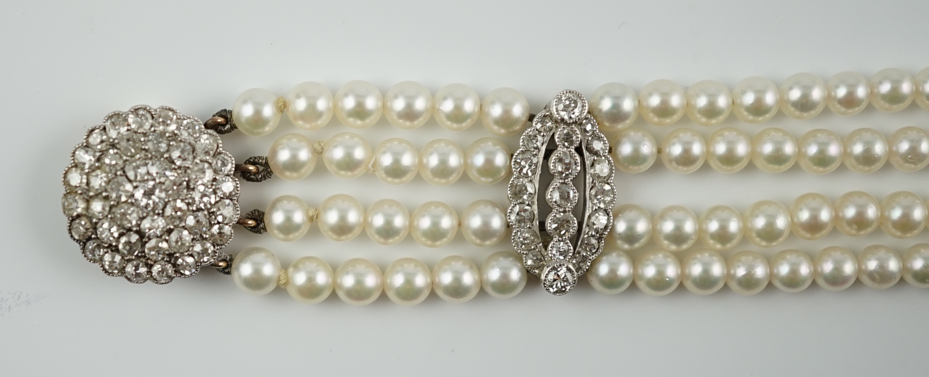 A multi-strand cultured pearl bracelet, with circular diamond cluster set gold clasp